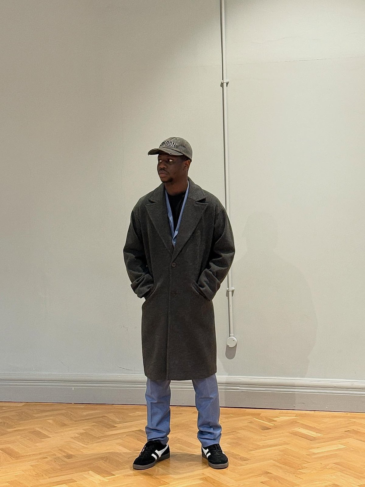 Jaaythecreator in a long coat, off duty